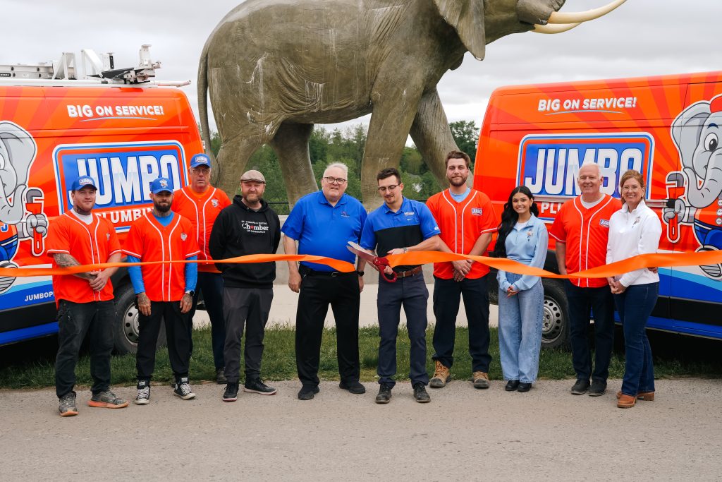 The Jumbo Plumbing Team ceremonial ribbon cutting in St. Thomas with the beloved Jumbo statue in the background.